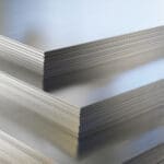Steel or aluminum sheets in warehouse, rolled metal product.